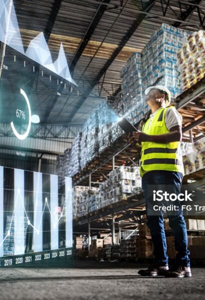 Employee analyzing virtual data with augmented reality interface in a warehouse