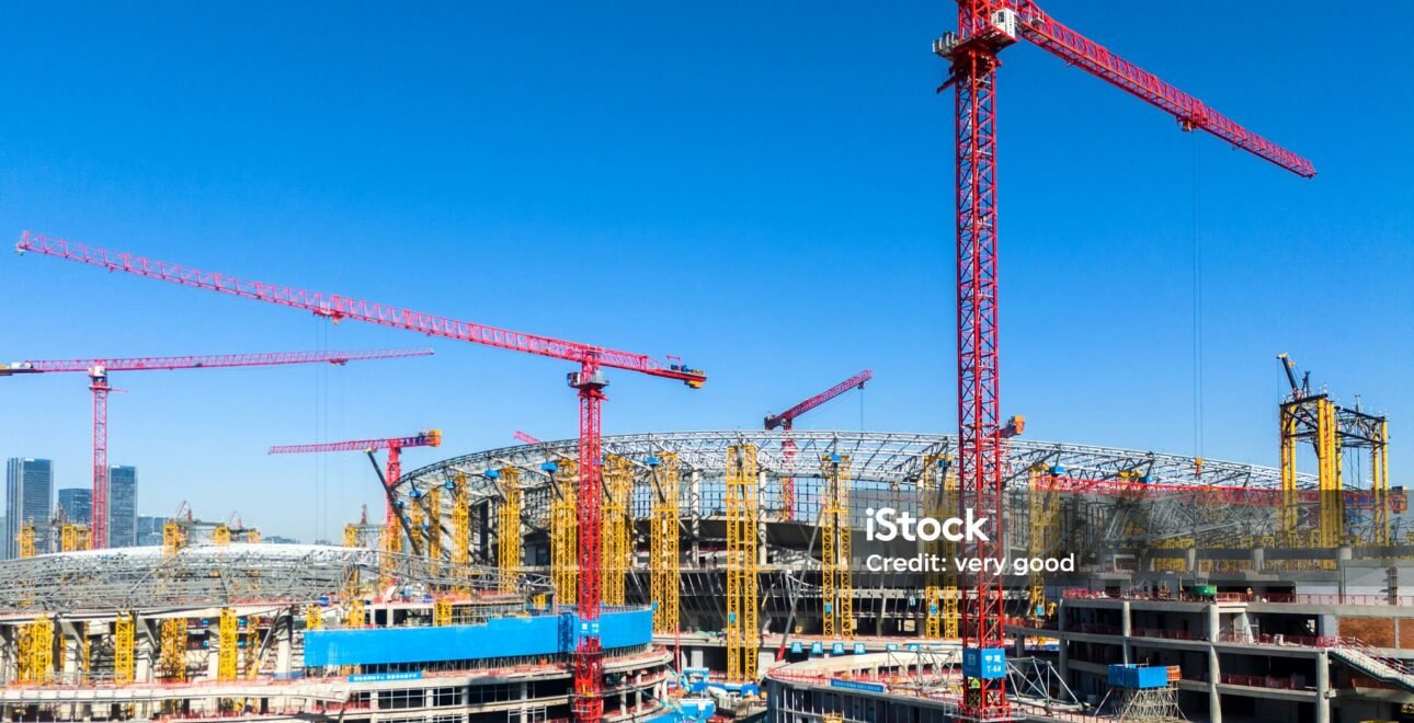 Construction site with tower cranes and unfinished buildings